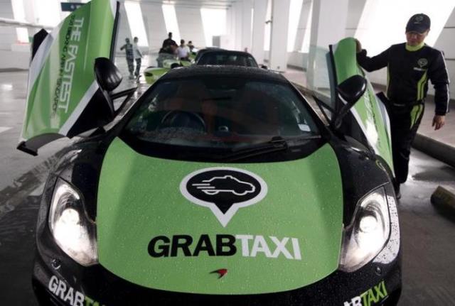 a driver checks his mclaren taxi after a photoshoot for taxi booking app grabtaxi 039 s fleet of seven luxury cars in singapore september 15 2015 photo reuters