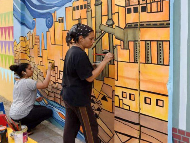 art teacher nooryya shaikh nabi right and her daughter gaiti ara rendering final touches to a design on a wall in karachi photo file art teacher nooryya shaikh nabi right and her daughter gaiti ara rendering final touches to a design on a wall in karachi photo file