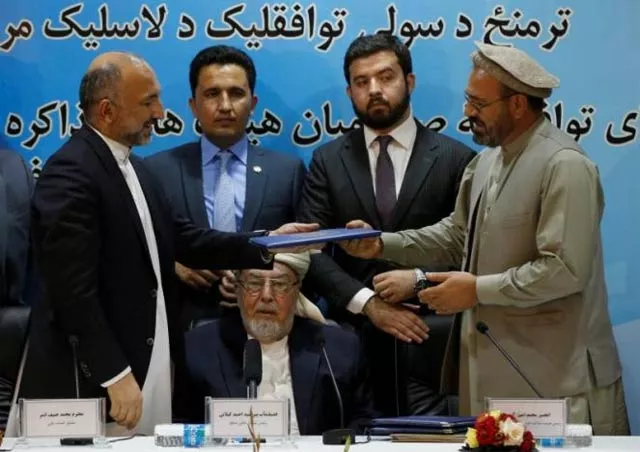 mohammad amin karim r representative of gulbuddin hekmatyar and afghanistan national security adviser mohammad hanif atmar l hold a document after signing a peace deal in kabul photo reuters mohammad amin karim r representative of gulbuddin hekmatyar and afghanistan national security adviser mohammad hanif atmar l hold a document after signing a peace deal in kabul photo reuters