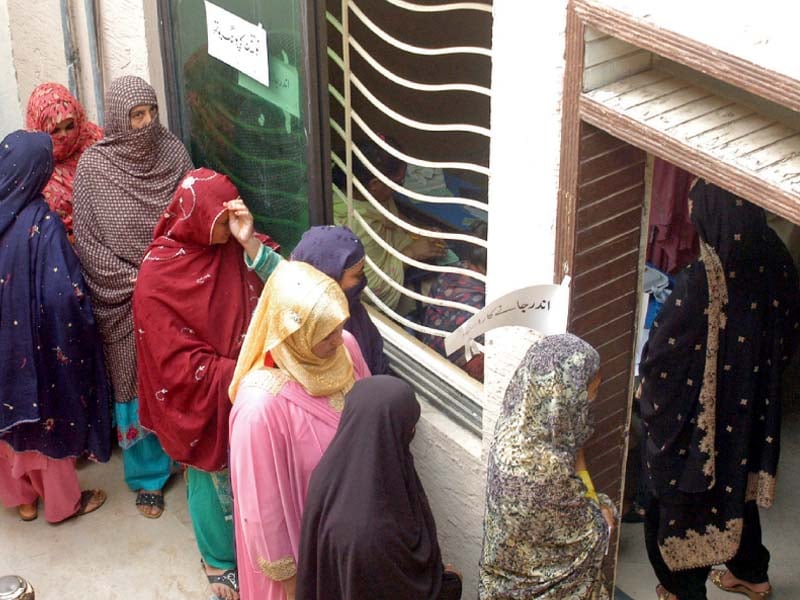 women wait to cast their votes for the election of the chairmen of union councils 48 and 49 in islamabad on saturday photo wasim nazir express