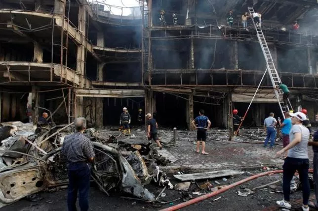 people gather at the site of a suicide car bomb in the karrada shopping area in baghdad iraq july 3 2016 photo reuters people gather at the site of a suicide car bomb in the karrada shopping area in baghdad iraq july 3 2016 photo reuters