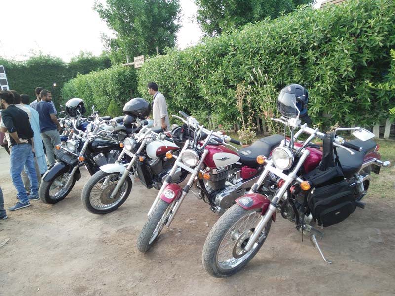 vintage motorcycles lined by the roadside photo ammar sheikh express