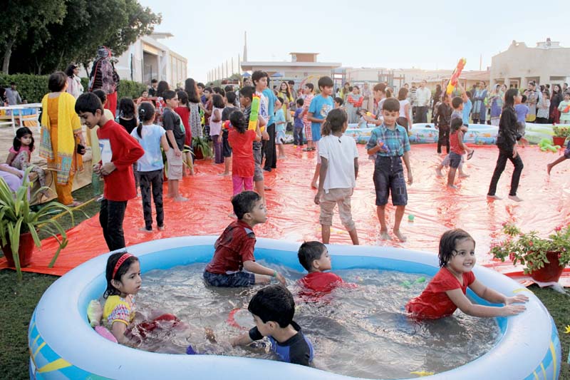 taking part in sports activities like the tug of war slip and slide water gun fight and bucket o relay the young attendees at the festival were completely immersed in the games and resultantly drenched in water photo ayesha mir express