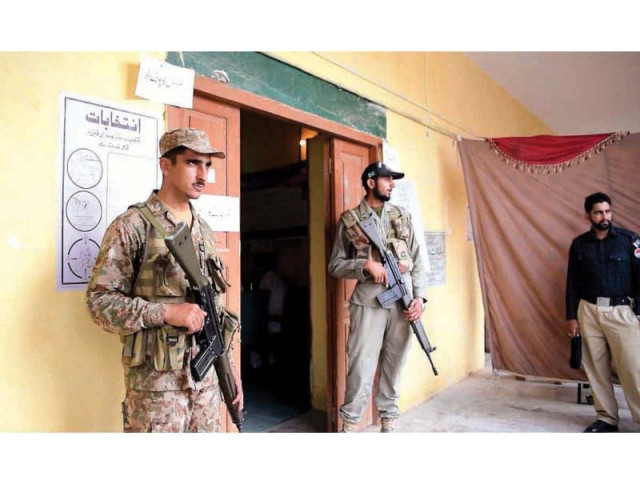 security officials stand alert at a polling station in taxila photo app security officials stand alert at a polling station in taxila photo app