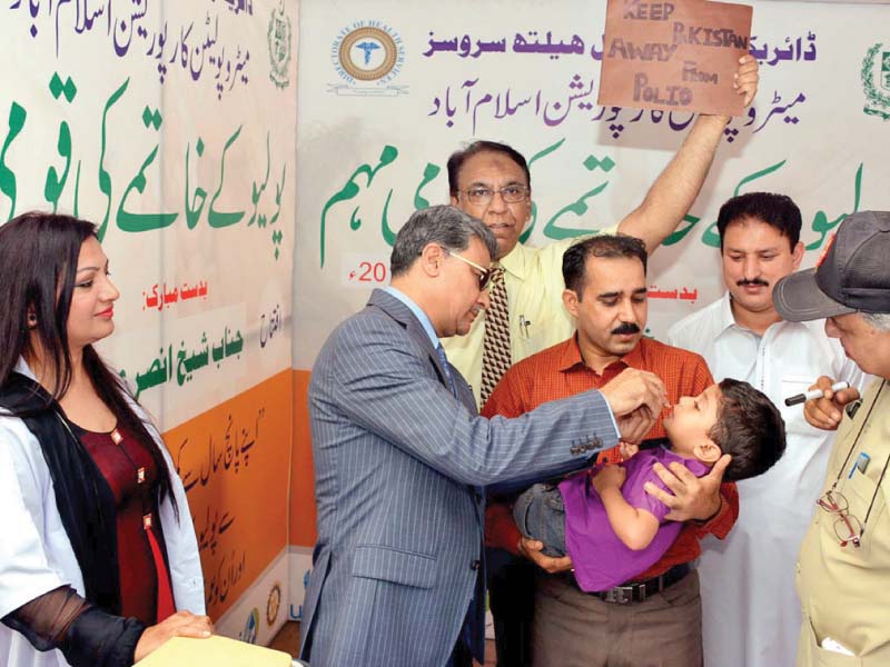 islamabad mayor anser aziz administers anti polio drops to a child to mark the start of the inoculation campaign in the capital photo inp