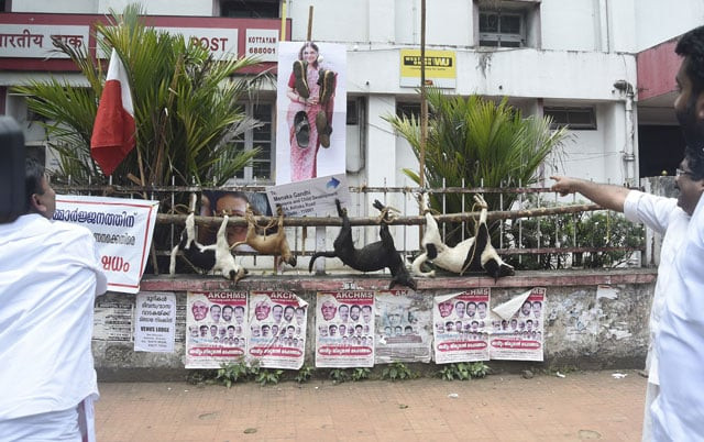 indian activists with the kerala congress youth front stand next to the bodies of dead dogs as they protest against dangerous strays in kottayam in the southern indian state of kerala on september 26 2016 photo afp