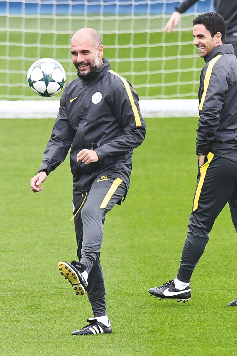 guardiola juggles the ball as he takes a team training session at the manchester city football academy campus ahead of their champions league clash against celtic photo afp