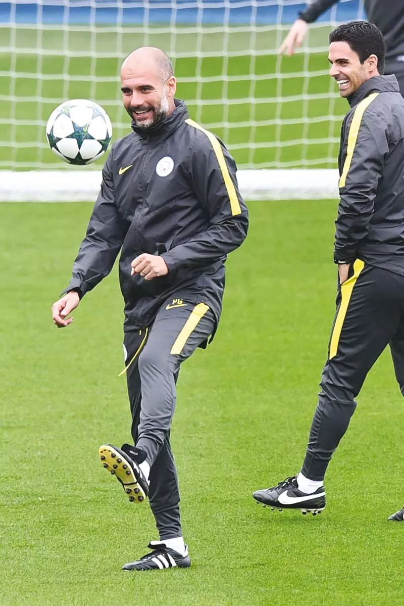 guardiola juggles the ball as he takes a team training session at the manchester city football academy campus ahead of their champions league clash against celtic photo afp guardiola juggles the ball as he takes a team training session at the manchester city football academy campus ahead of their champions league clash against celtic photo afp