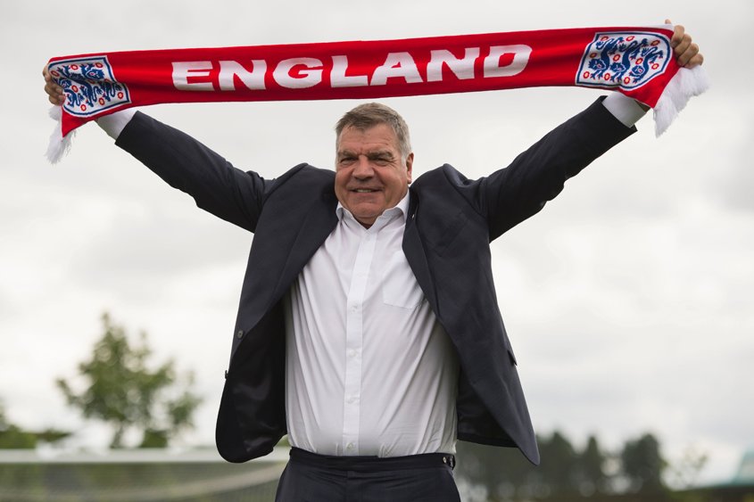 this file photo taken on july 25 2016 shows england football team manager sam allardyce holding up an england scarf during a photocall at st george 039 s park near burton on trent central england photo afp