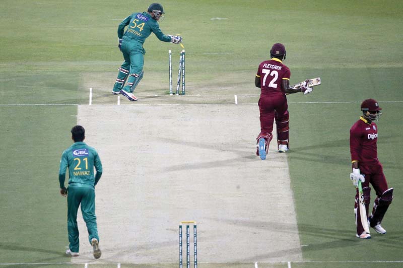 sarfraz ahmed hits the stumps to run out andre fletcher during the 3rd t20i match between pakistan and the west indies in abu dhabi photo afp