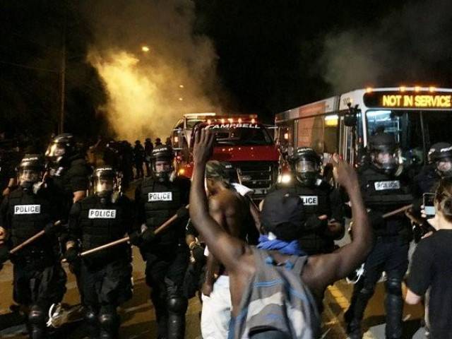 police officers wearing riot gear block a road during protests after police fatally shot keith lamont scott in the parking lot of an apartment complex in charlotte north carolina u s september 20 2016 photo reuters