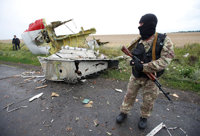 a pro russian separatist stands at the crash site of malaysia airlines flight mh17 near the village of hrabove grabovo in donetsk region ukraine july 18 2014 photo reuters