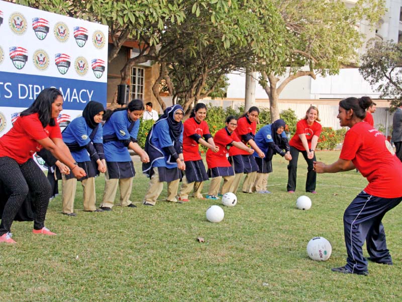 young women enjoy a game of volleyball with us consul general grace shelton at her residence on wednesday photos ayesha mir express