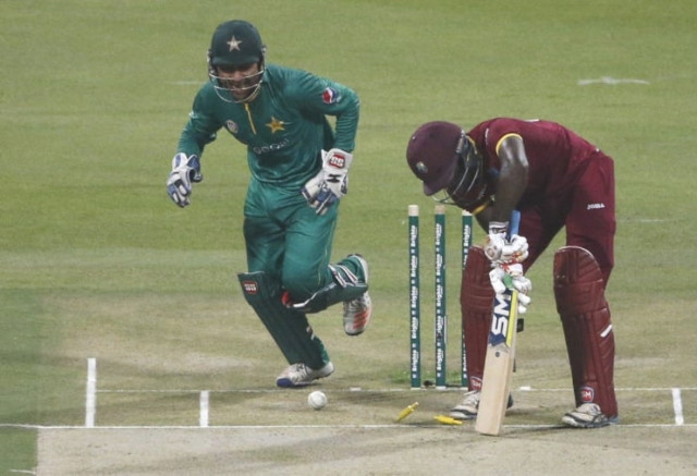 pakistan t20i captain sarfraz ahmed l celebrates after wicket of chadwick walton r on september 27 2016 photo afp