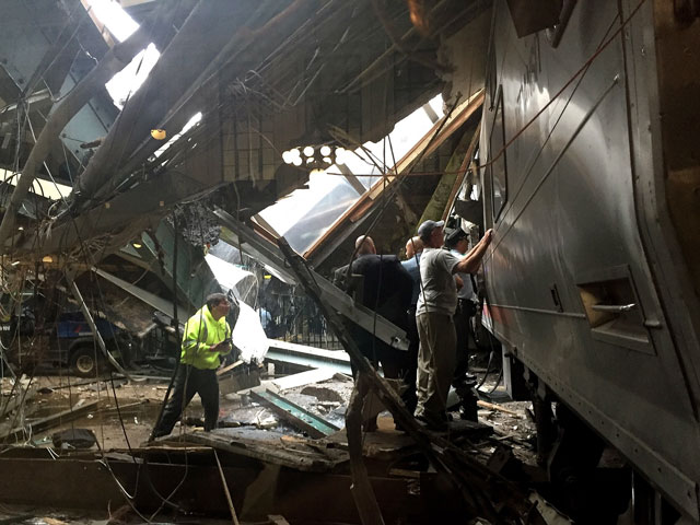 train personnel survey the nj transit train that crashed in to the platform at the hoboken terminal september 29 2016 in hoboken new jersey photo afp