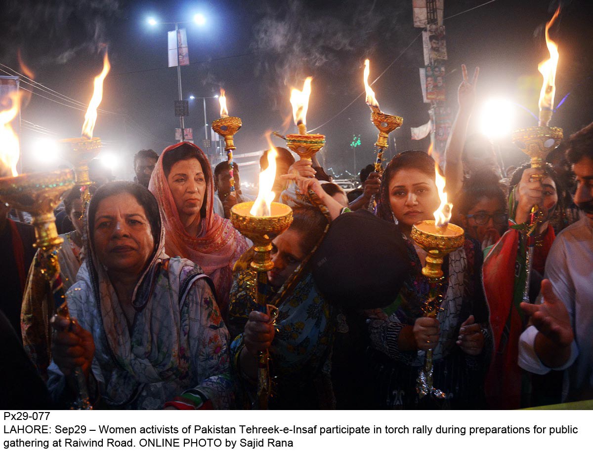 women activists of pti participate in torch rally during preperations for public gathering at raiwind road photo online