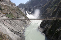 labourers walk on a bridge near the newly inaugurated 450 megawatt hydropower project located at baglihar dam on the chenab river which flows from indian kashmir into pakistan at chanderkote about 145 km 90 miles north of jammu october 10 2008 reuters
