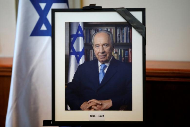 a photograph of former israeli president shimon peres is displayed before the start of a special cabinet meeting to mourn the death of peres in jerusalem photo reuters