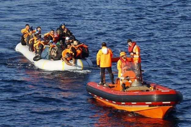 a turkish coast guard fast rigid hulled inflatable boats tow refugees and migrants in a dinghy on the turkish territorial waters photo reuters