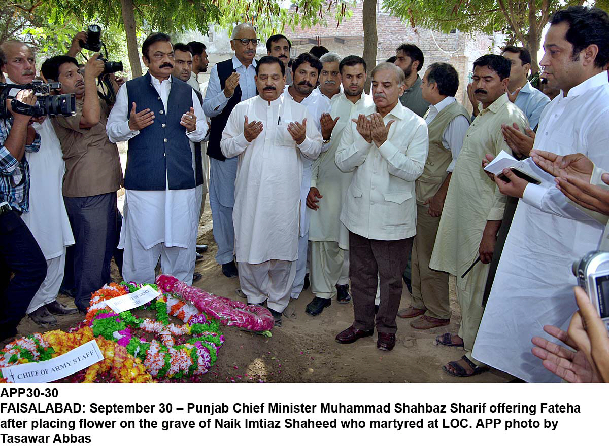 shehbaz also visited the local graveyard at hajveri town on sargodha road and placed a bouquet and a wreath on the grave of the martyr photo inp