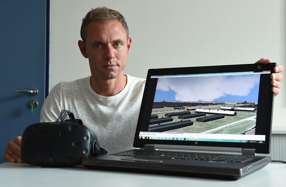 ralf breker of the bavarian criminal police posing with virtual reality glasses and a computer which shows a picture from the 3d model of the former nazi concentration camp auschwitz photo afp