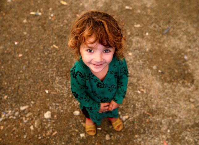 an afghan refugee girl returning from pakistan looks on after she arrives at a united nations high commissioner for refugees unhcr registration centre in kabul afghanistan photo reuters