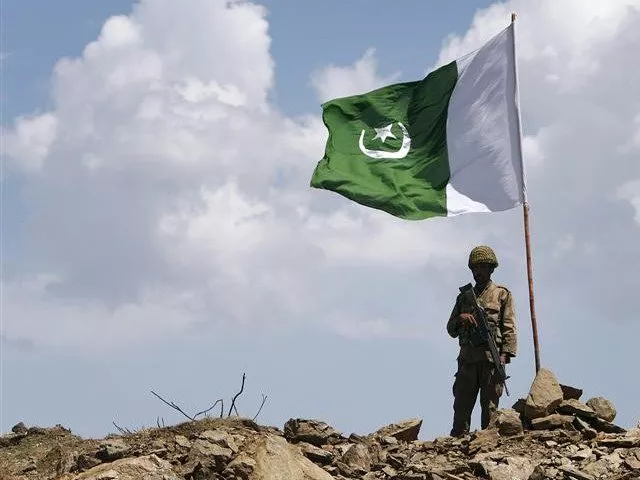 a soldier stands next to a pakistani flag photo reuters a soldier stands next to a pakistani flag photo reuters