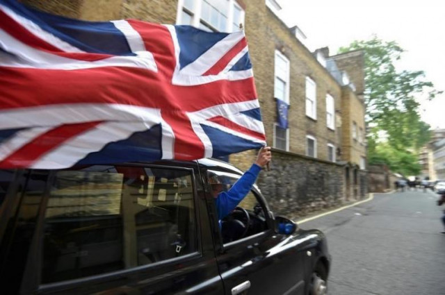 a taxi driver holds a union flag as he celebrates following the result of the eu referendum in central london britain june 24 2016 photo reuters a taxi driver holds a union flag as he celebrates following the result of the eu referendum in central london britain june 24 2016 photo reuters