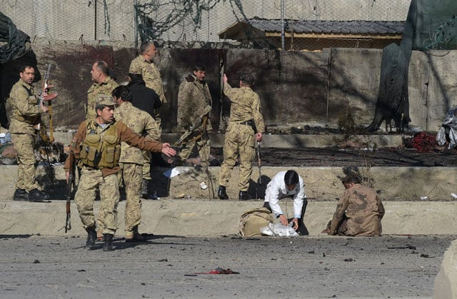 afghan security personnel gather as victims are treated at the site of a suicide car bomb next to a police base in kabul on february 1 2016 photo afp afghan security personnel gather as victims are treated at the site of a suicide car bomb next to a police base in kabul on february 1 2016 photo afp