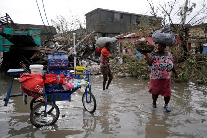 residents walk in flooded area after hurricane matthew in les cayes haiti october 5 2016 photo reuters