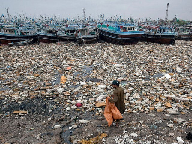 a boy looks for recyclable items in the polluted waters of karachi harbour pakistan photo reuters a boy looks for recyclable items in the polluted waters of karachi harbour pakistan photo reuters