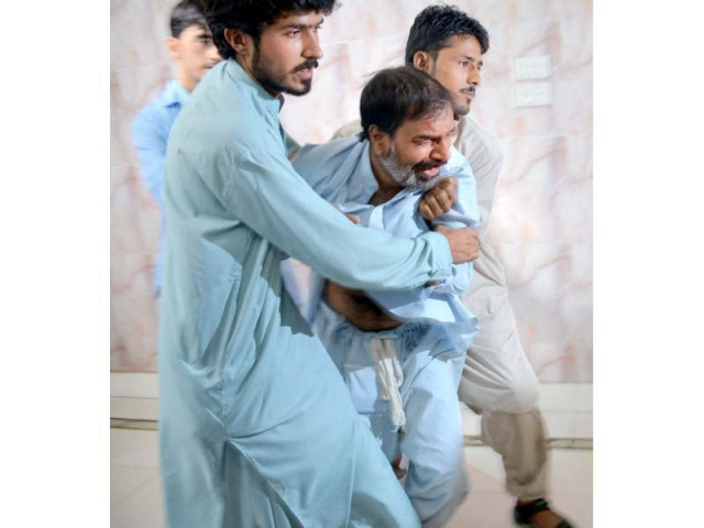 a relative of one of the victims weeps near where jaffar express was targeted with bombs in bolan photo afp a relative of one of the victims weeps near where jaffar express was targeted with bombs in bolan photo afp