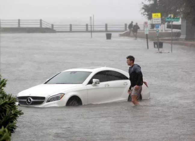 a resident walks through flood waters next to a partially submerged car on east battery street at the southern most tip of the city as hurricane matthew hits charleston south carolina october 8 2016 photo reuters a resident walks through flood waters next to a partially submerged car on east battery street at the southern most tip of the city as hurricane matthew hits charleston south carolina october 8 2016 photo reuters