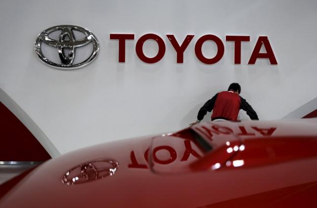 an employee works under a toyota motor corp logo at the company 039 s showroom in tokyo japan on february 5 2016 photo reuters