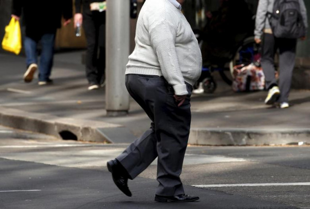 a man crosses a main road as pedestrians carrying food walk along the footpath in central sydney australia photo reuters a man crosses a main road as pedestrians carrying food walk along the footpath in central sydney australia photo reuters