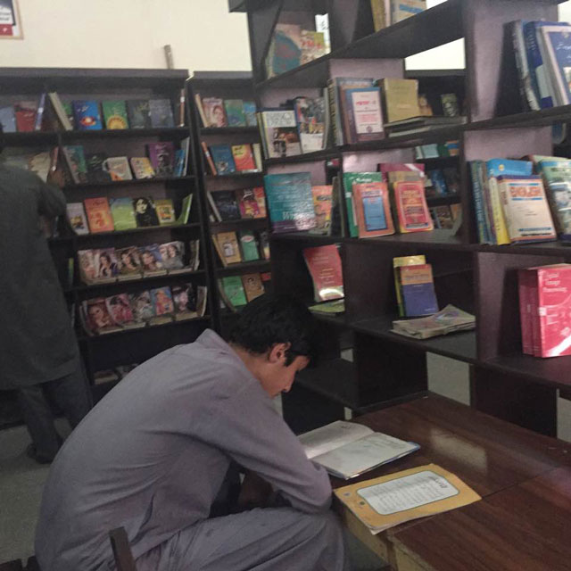 a young man reads a book in the newly built library in bara bazaar photo express