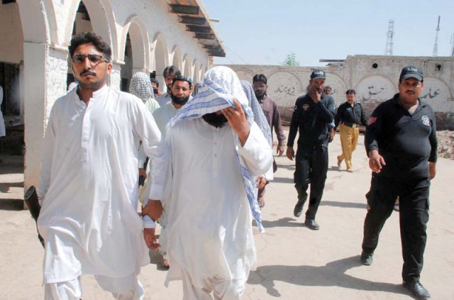 law enforcement personnel taking away a suspect after raiding a seminary in sukkur photo inp law enforcement personnel taking away a suspect after raiding a seminary in sukkur photo inp