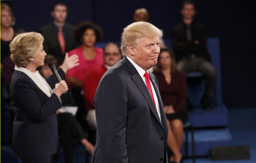 republican us presidential nominee donald trump listens as democratic us presidential nominee hillary clinton l speaks during their presidential town hall debate at washington university in st louis missouri u s october 9 2016 photo reuters