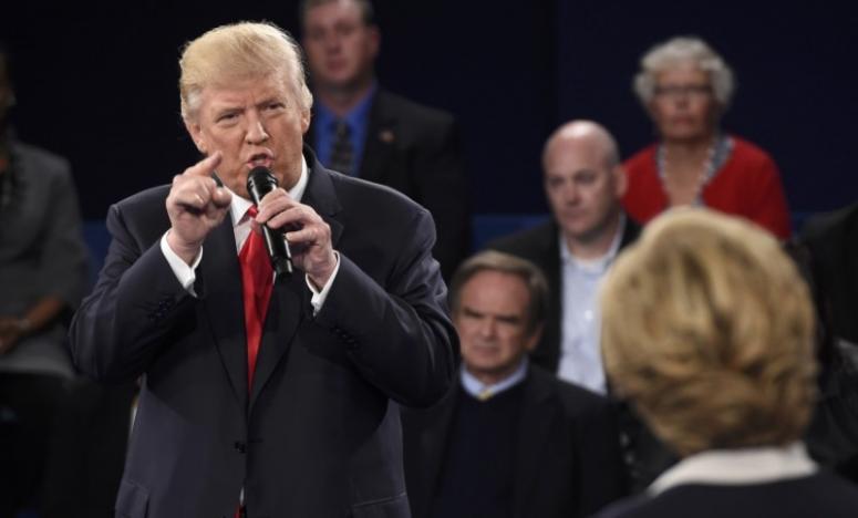 republican us presidential nominee donald trump speaks as democratic us presidential nominee hillary clinton r listens during their presidential town hall debate photo reuters