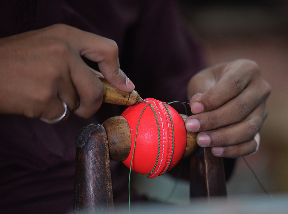 a pakistani worker stitches a pink cricket ball at the grays of cambridge factory in sialkot pakistan 039 s sports goods industry is positioning itself to be the prime manufacturer of pink cricket balls    a high visibility alternative for use in day night test matches aimed at dragging the game into the 21st century photo afp