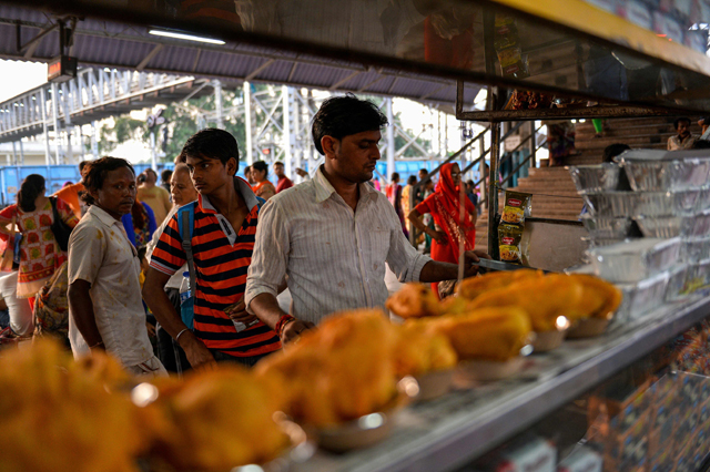 in this photograph taken on august 26 2016 an employee of indian railways prepairs food at the food stall on a platform inside the mahura railway junction in mathura photo afp