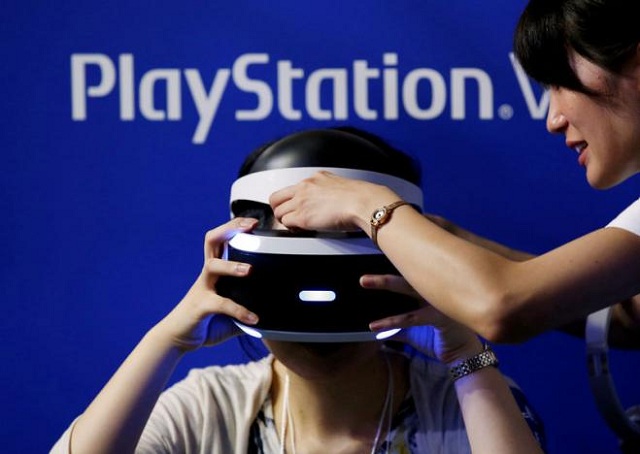 a hostess helps a woman to wear sony 039 s playstation vr headset at tokyo game show photo rueters