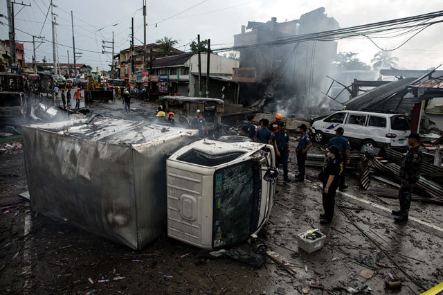 a truck was turned over after an explosion during a fire at fireworks shop in bocaue bulacan north of manila on october 12 2016 photo afp