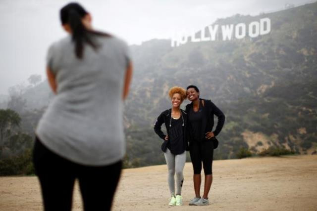 hikers pose for a photo in front of the hollywood sign on a foggy day in los angeles california photo reuters hikers pose for a photo in front of the hollywood sign on a foggy day in los angeles california photo reuters