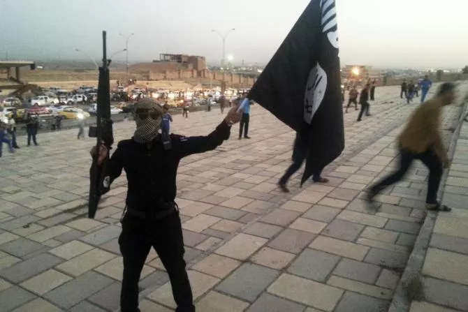 a fighter of the islamic state of iraq and the levant isil holds an isil flag and a weapon on a street in the city of mosul iraq june 23 2014 photo reuters a fighter of the islamic state of iraq and the levant isil holds an isil flag and a weapon on a street in the city of mosul iraq june 23 2014 photo reuters