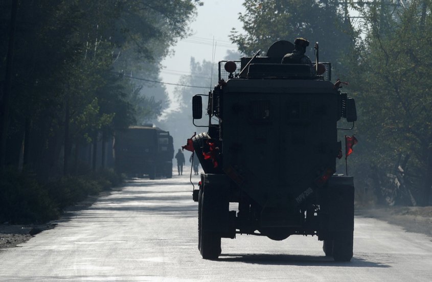 an indian army vehicle drives near the scene during the second day of a gunfight between the army and suspected militants in pampore south of srinagar on october 11 2016 photo afp