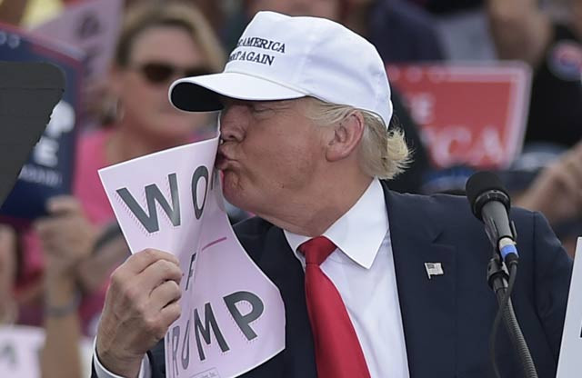 republican presidential nominee donald trump kisses a quot women for trump quot placard during a rally at the lakeland linder regional airport in lakeland florida photo afp republican presidential nominee donald trump kisses a quot women for trump quot placard during a rally at the lakeland linder regional airport in lakeland florida photo afp