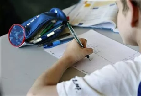 a schoolboy studies during a morning class in a primary classroom photo reuters a schoolboy studies during a morning class in a primary classroom photo reuters