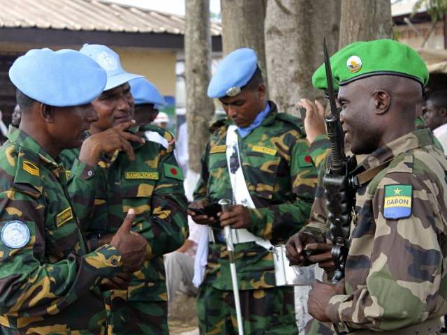 gabonese soldiers from misca green berets speak to minusca soldiers blue berets in bangui central african republic photo afp