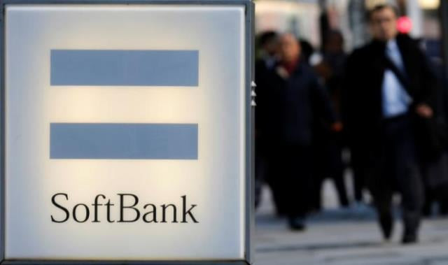 people walk behind the logo of softbank corp in tokyo december 18 2014 photo reuters people walk behind the logo of softbank corp in tokyo december 18 2014 photo reuters
